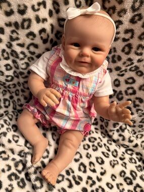 Realistic Baby Girl Doll in Pink Plaid Outfit with White Headband